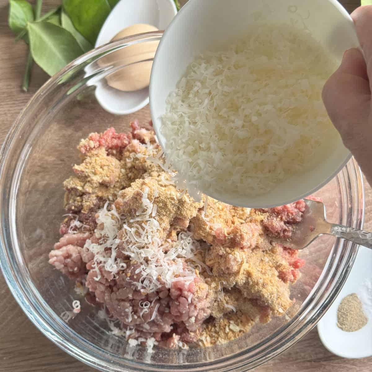 Adding cheese to the mixture.