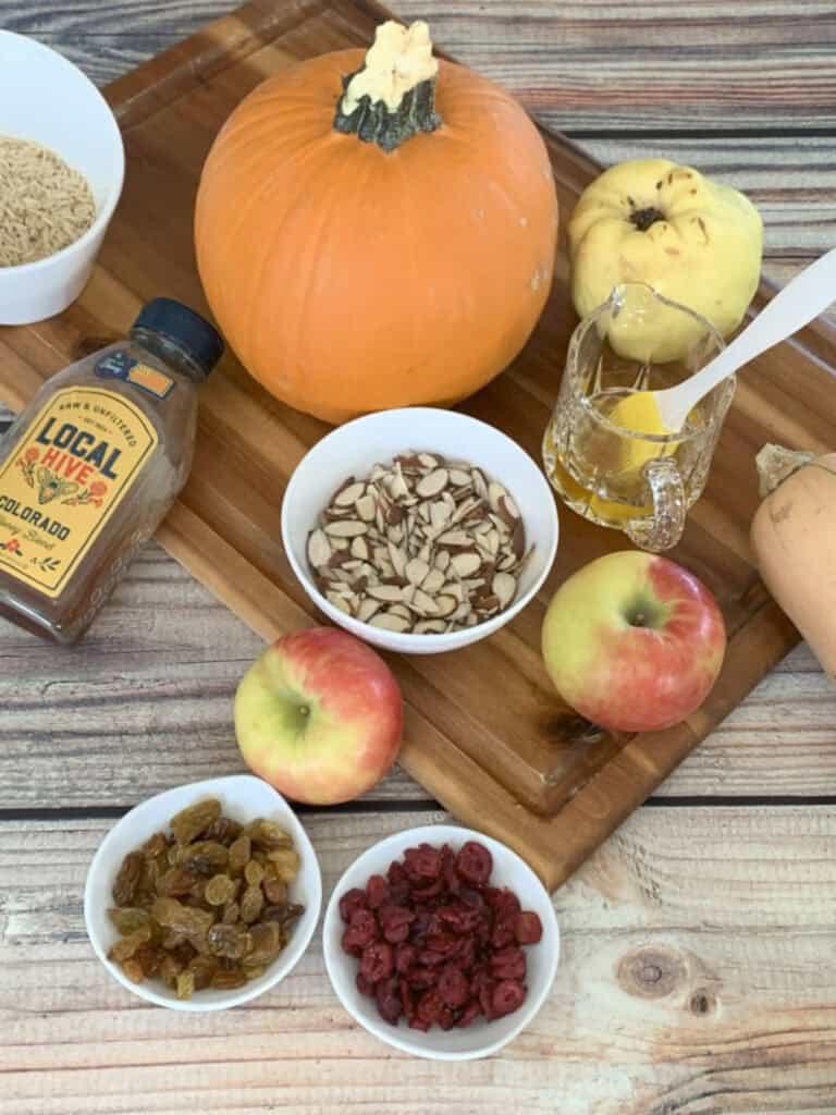 Ingredients for ghapama such as rice, pumpkin, nuts, and fruits.