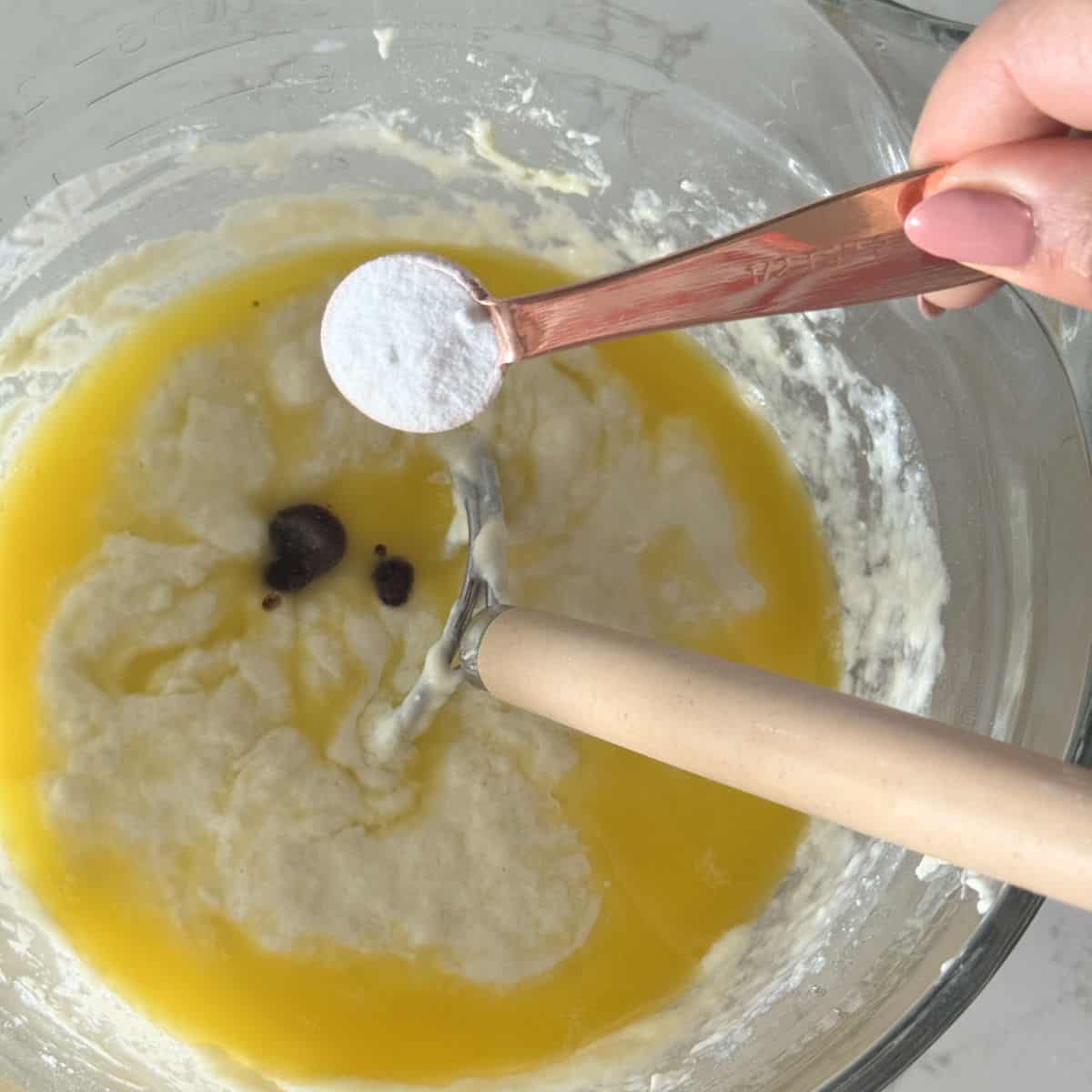 Making kefir waffle batter by adding the sugar, vanilla and baking soda.