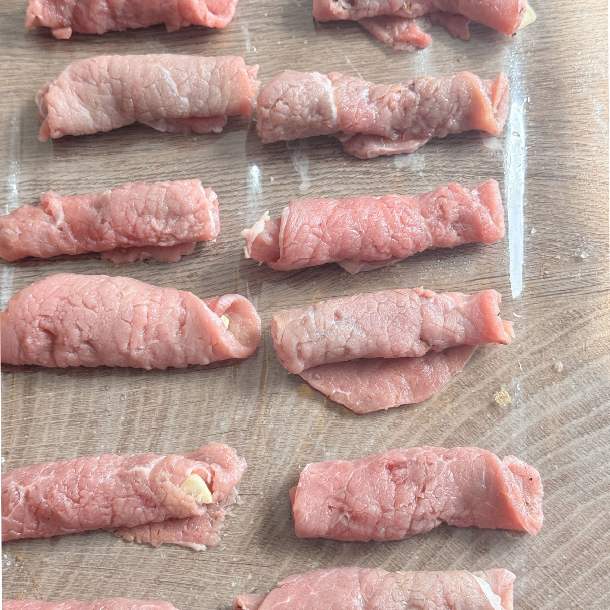 Process shots o making roasto, rolling up the beef.