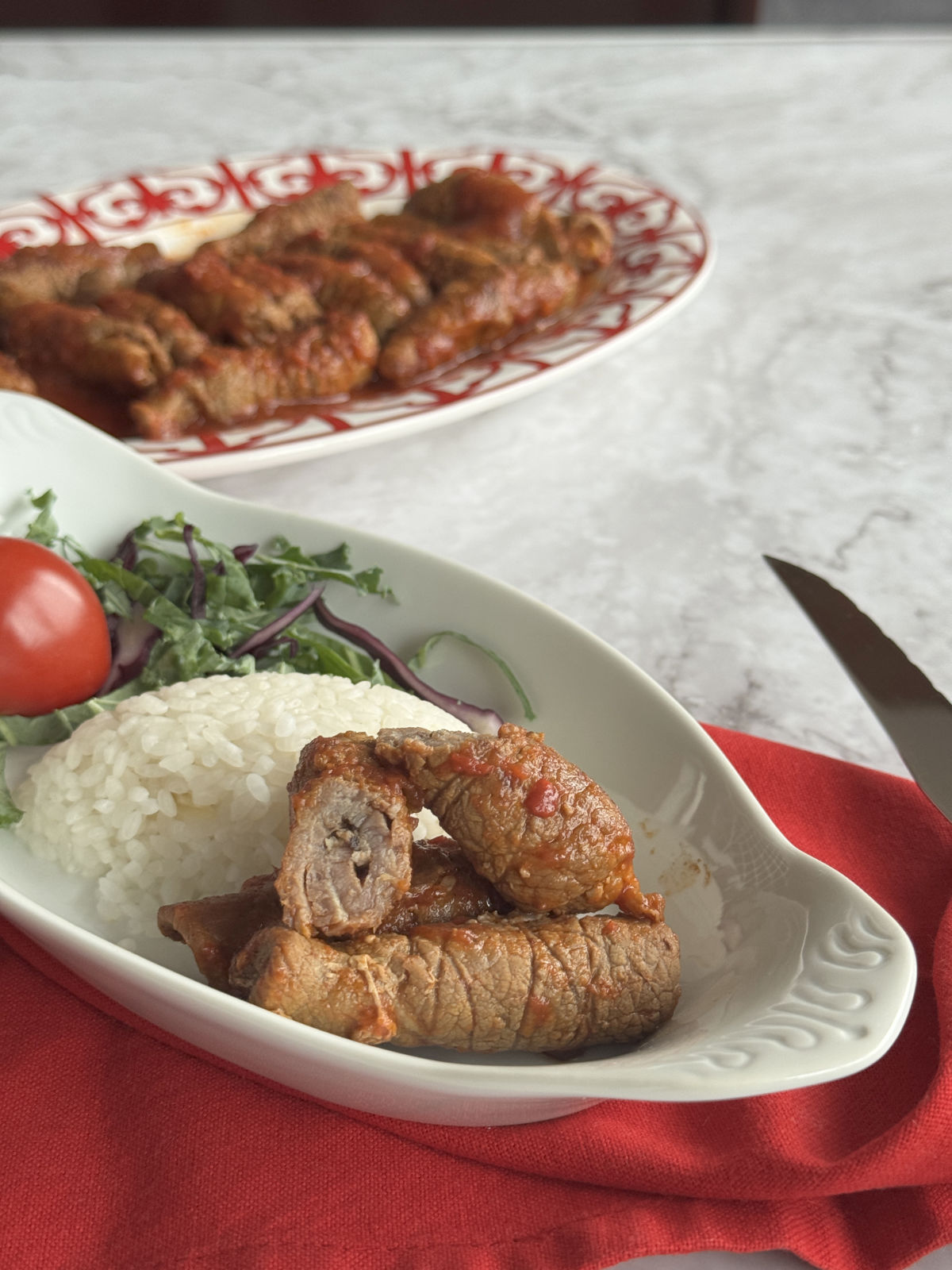 Cross cut of the Armenian Roasto and the full platter in the background.