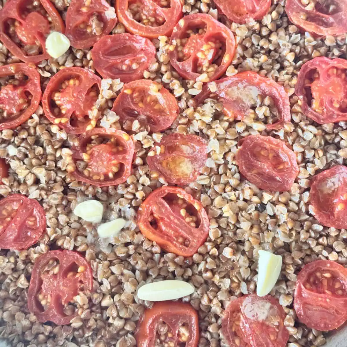 Adding dollops of butter on cooked buckwheat pilaf.