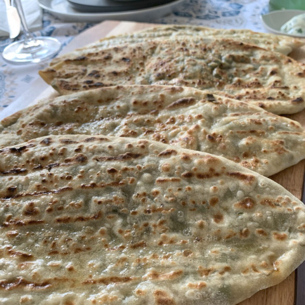 Three Jingalov Hats served on a wooden board.