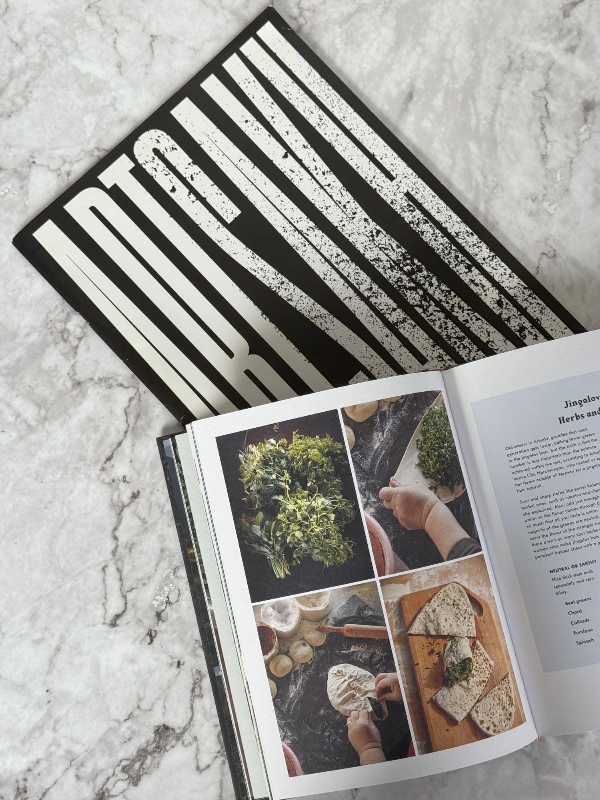 Artsakh and lavash book on a table.