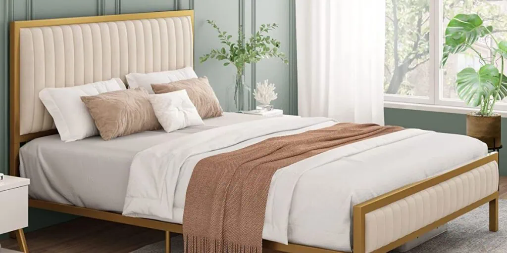 neutral bed in front of a green/gray wall focal point