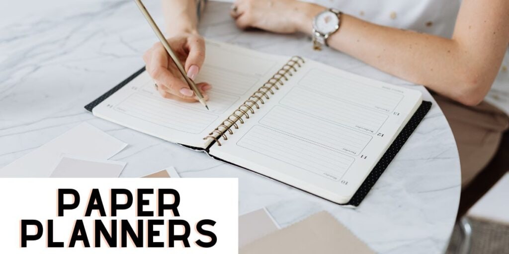 woman writing in her paper planner