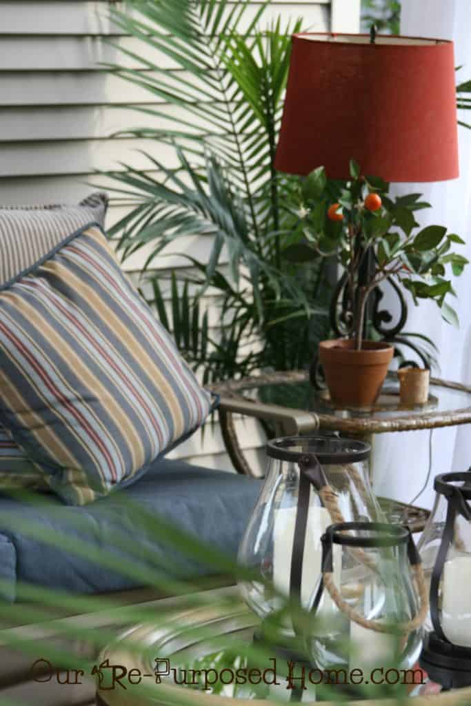 outdoor swing with side tables and lamp