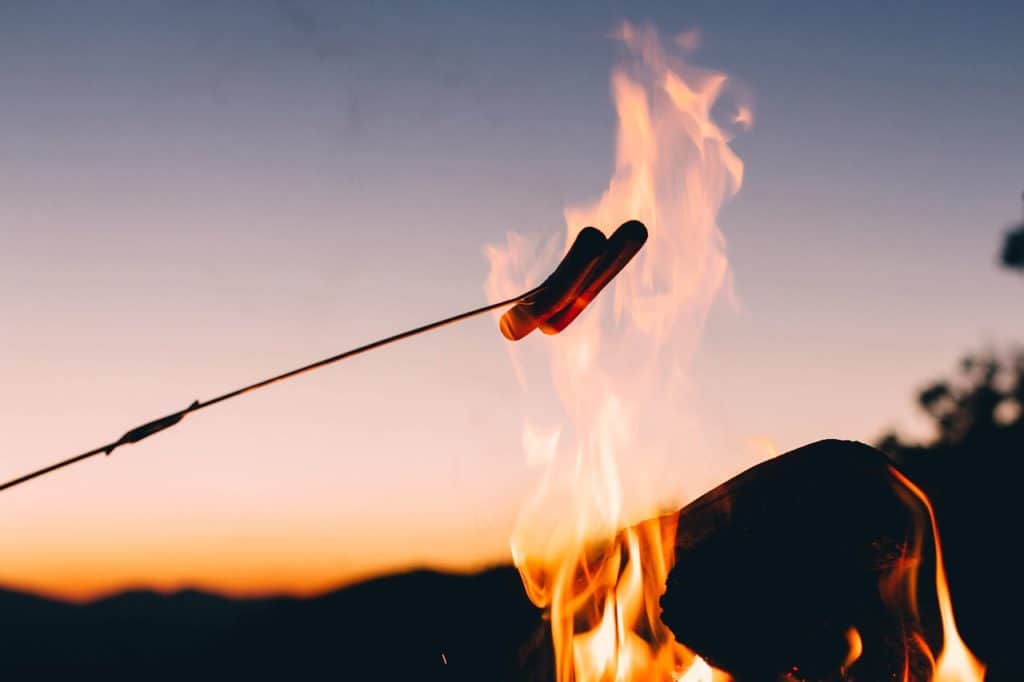 Fall toasting hot dogs over a fire