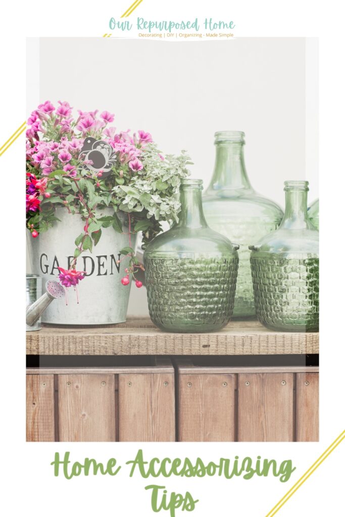 Flower arrangement with green glass bottles example of how to accessorize