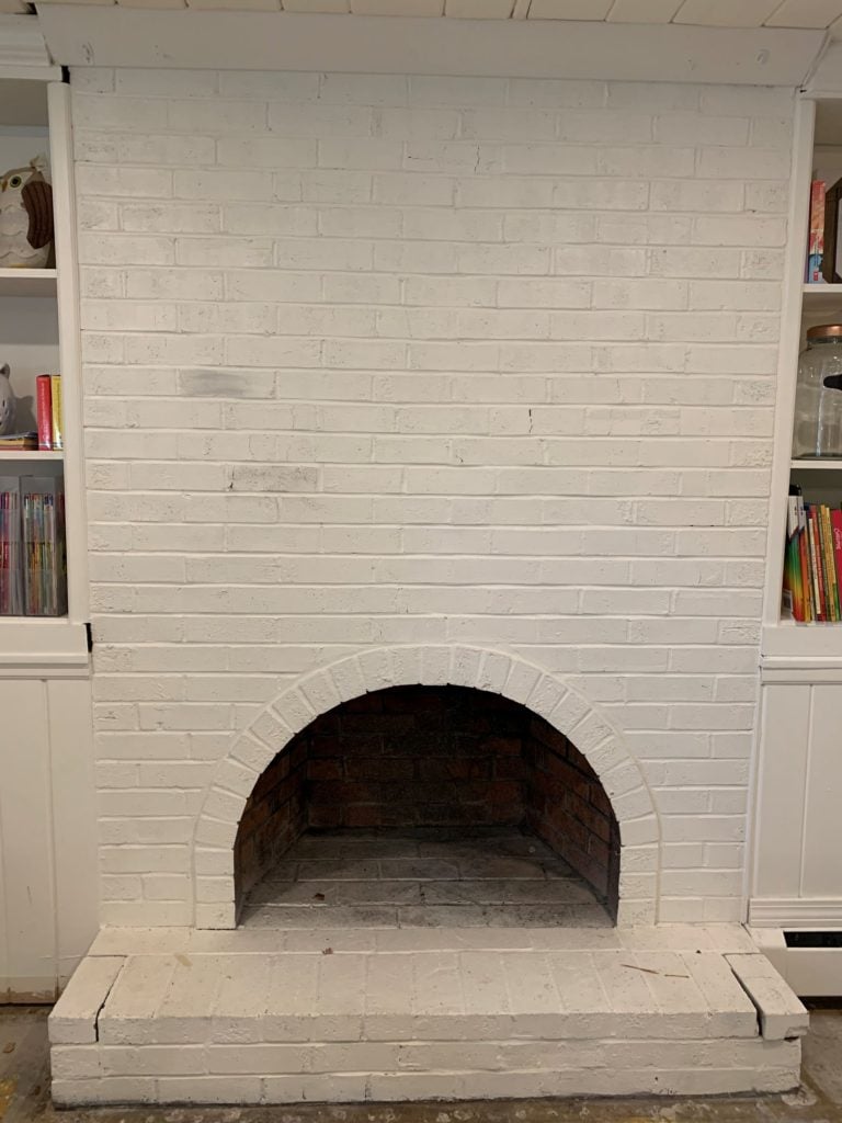painted fireplace before stripping