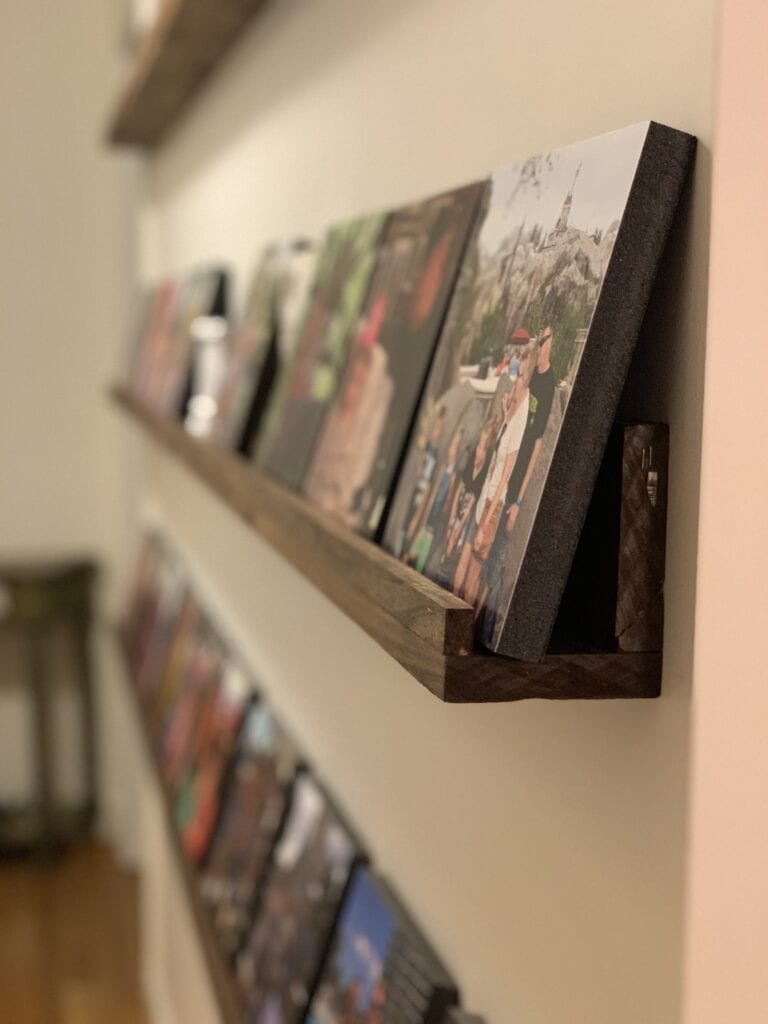 Mixtiles photos arranged on a picture ledge