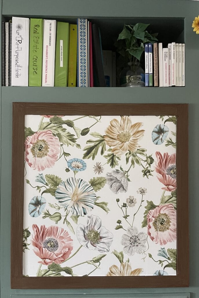old cabinet door with floral wallpaper insert