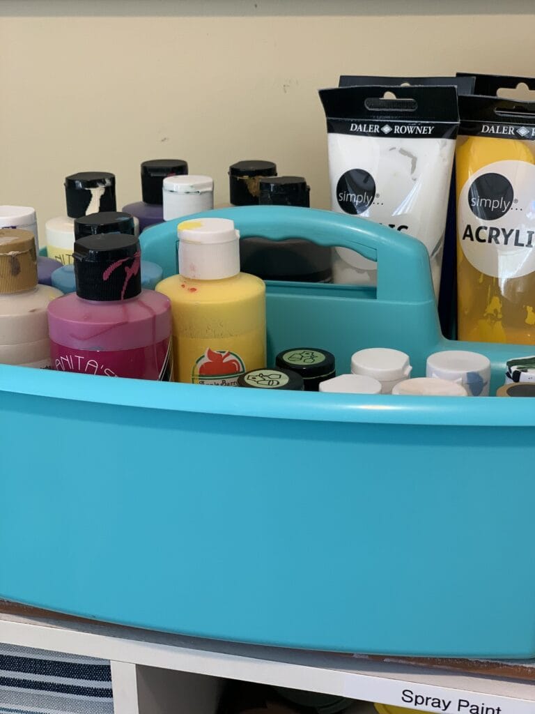 blue plastic storage tote with paints