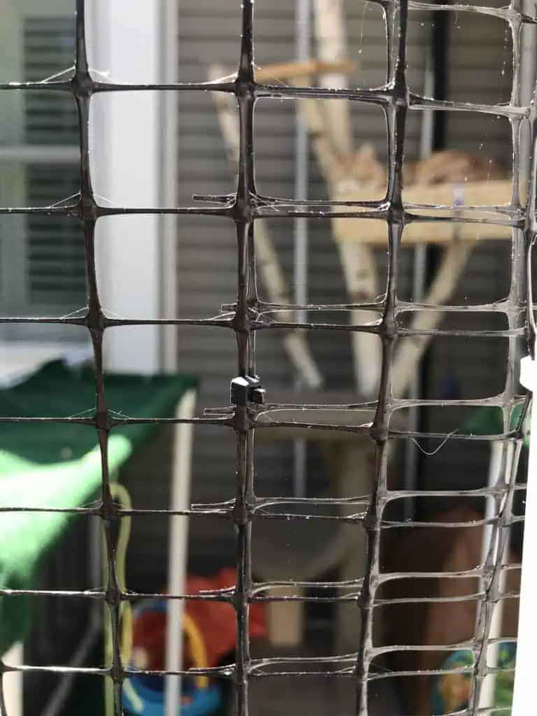 close up of netting attached with zip ties for a custom made catio or cat enclosure made with PVC