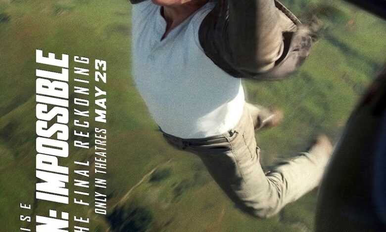 Daring stunt scene from Mission Impossible with a man hanging from a helicopter.