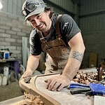 Handcrafted wooden furniture being made by skilled carpenter in workshop.
