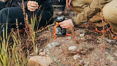 Outdoor Insight portable camping stove and cookware in outdoor setting.