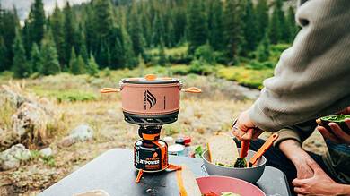 Outdoor Insight portable camping stove with compact design for outdoor cooking.