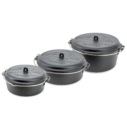 Set of three Petromax cast iron cookware with lids for outdoor cooking.
