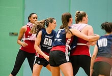 Outdoor Insight logo on netball players during a match or training session.