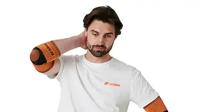 Man wearing orange elbow supports for tennis elbow recovery.
