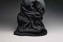 Crushed black hoodie with zipper pocket on a grey background.