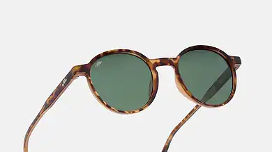 Tortoise brown sunglasses with green lenses for outdoor activities.
