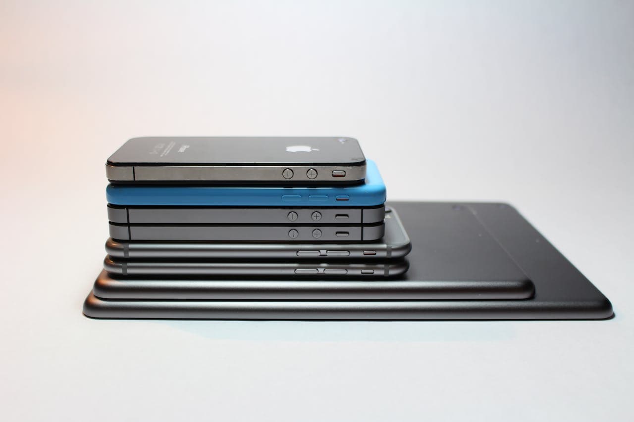 about-03 Stacked modern smartphones and tablets showcasing sleek design. Perfect tech background.