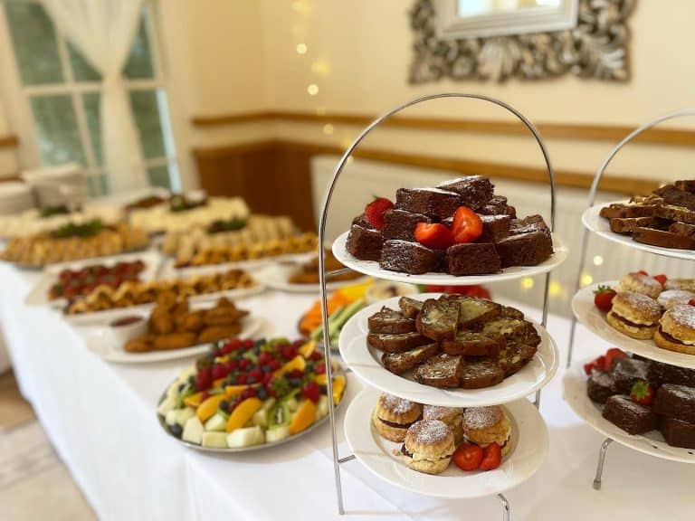Assorted desserts on a tiered stand at a wedding.
