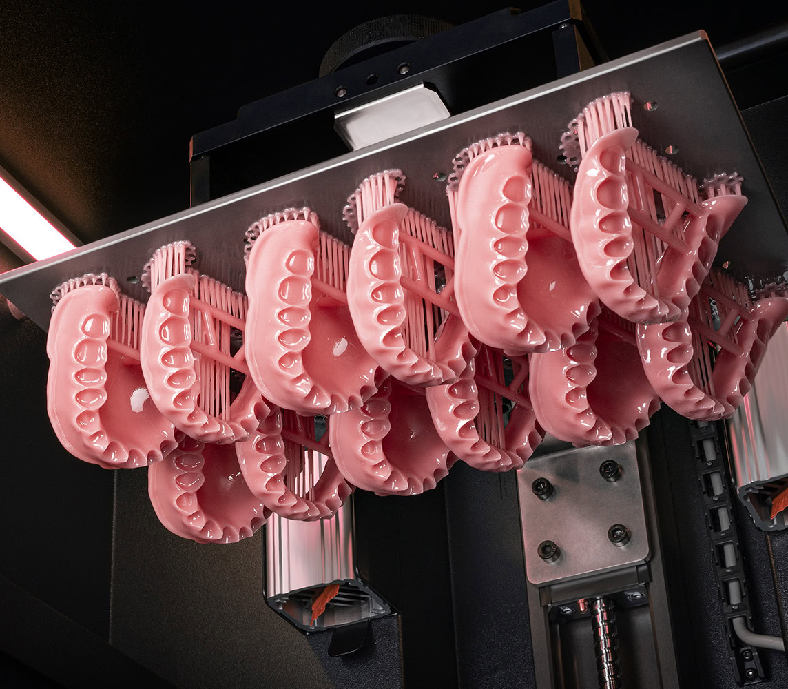 Image showing D50+ 3D printer with dentur bases printed with force feedback technology