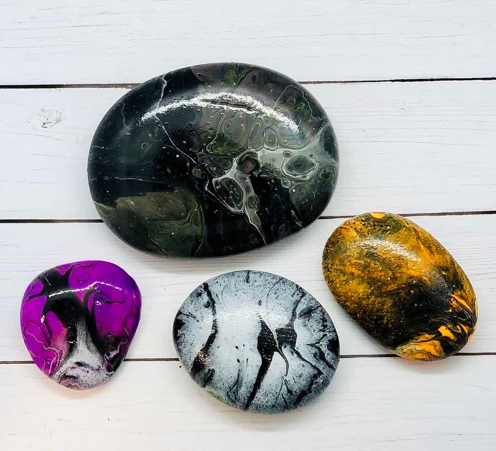 Try this Spooky Halloween Paint Pouring on Rocks Activity 4 halloween paint pouring on rocks