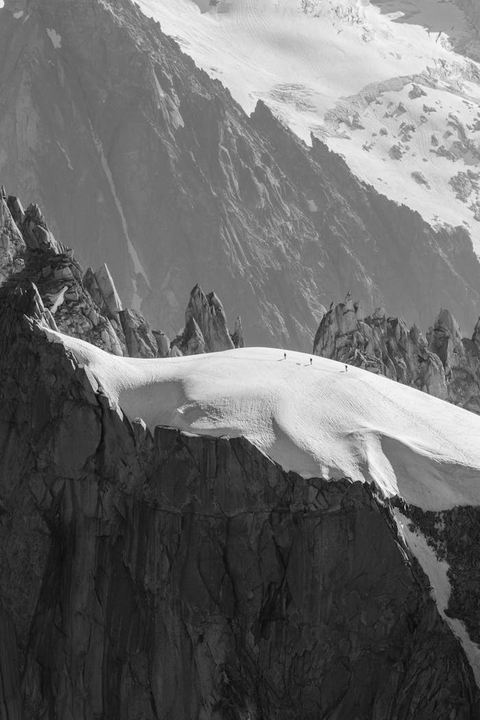 about-06 Alpinists traversing snowy Aiguille du Midi in Chamonix, France.