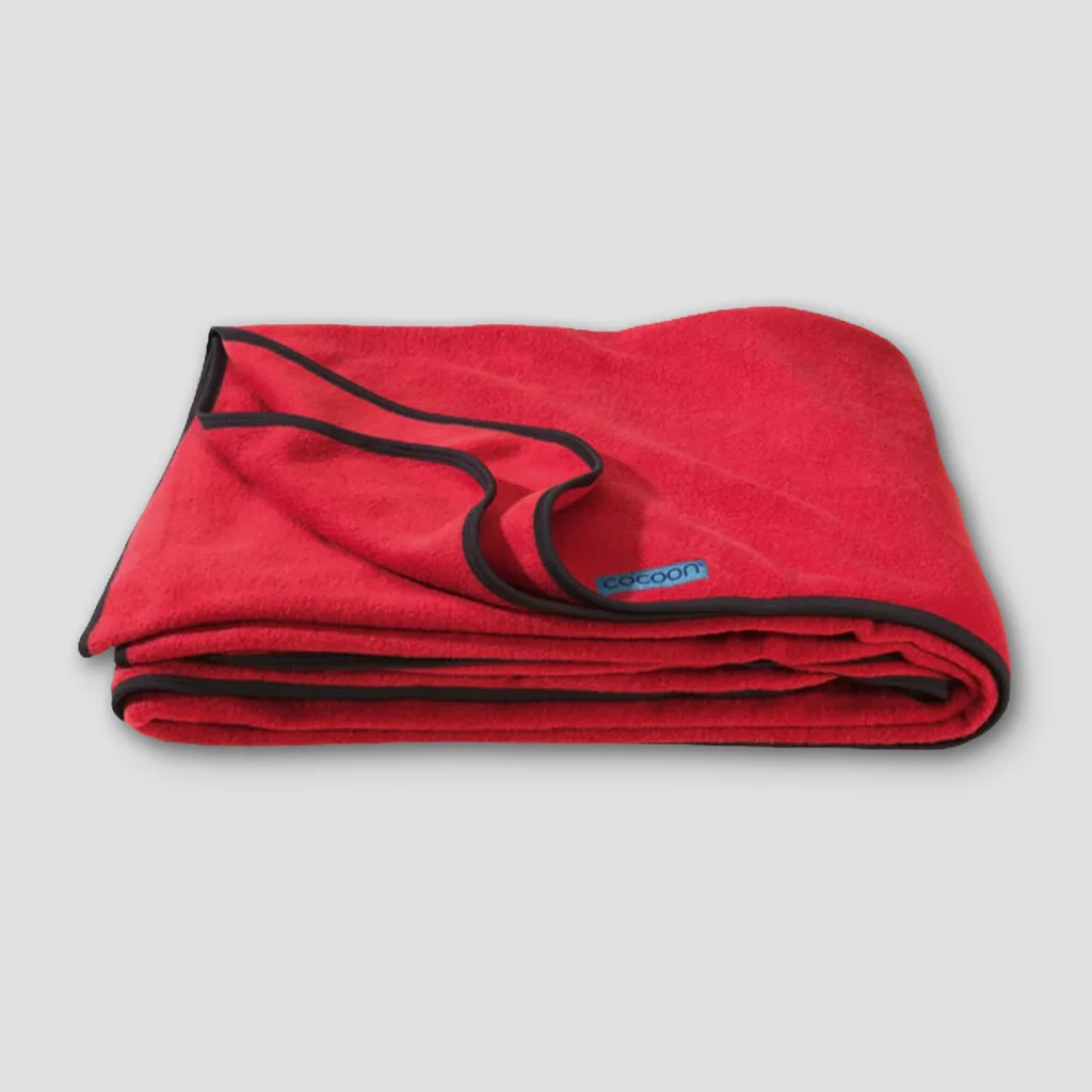 A product image for a fleece travel blanket from the brand Cocoon. Clicking this image will take you to the product page