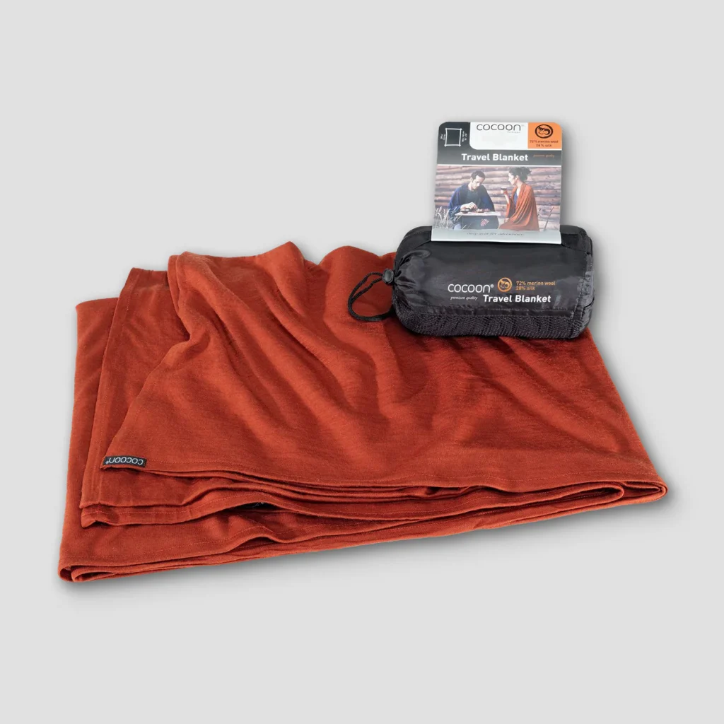 A product image for a merino wool travel blanket from the brand Cocoon. Clicking this image will take you to the product page