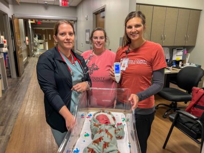 Nurses Stephanie Singh, Nicole Kirnie, and Whitney Winder demonstrated how easy and quick it is to use the Dräger jaundice meter with newborn Samuel, who passed his screening.