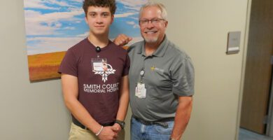 Nex-Gen intern Michael Ferguson poses with Dr. Ferrill Conant outside his office.