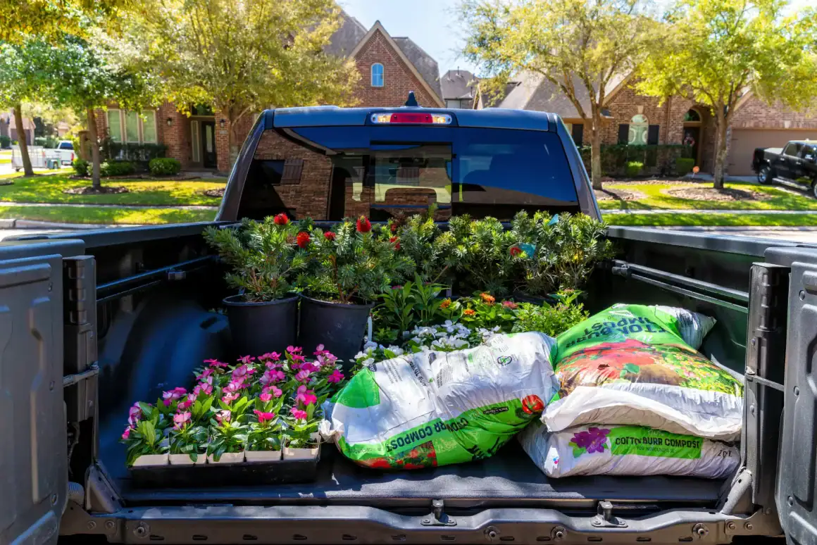 High-quality pickup truck with gardening supplies in the truck bed.