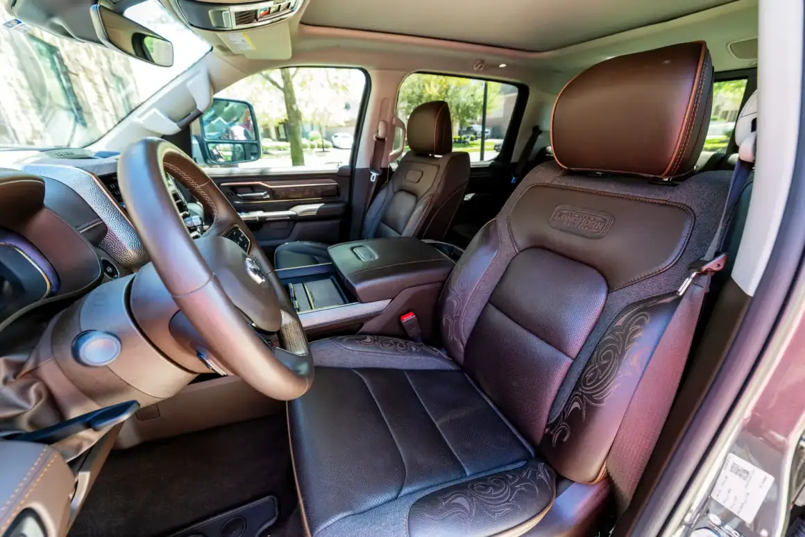 Luxury Ram 1500 Limited Longhorn truck cabin with premium leather seats and wood accents.