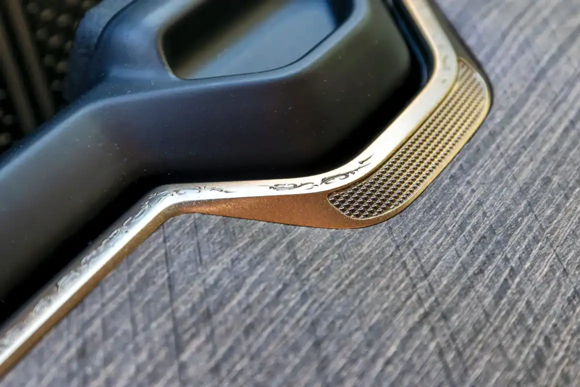 Luxury car door handle with metallic accents and textured grip.