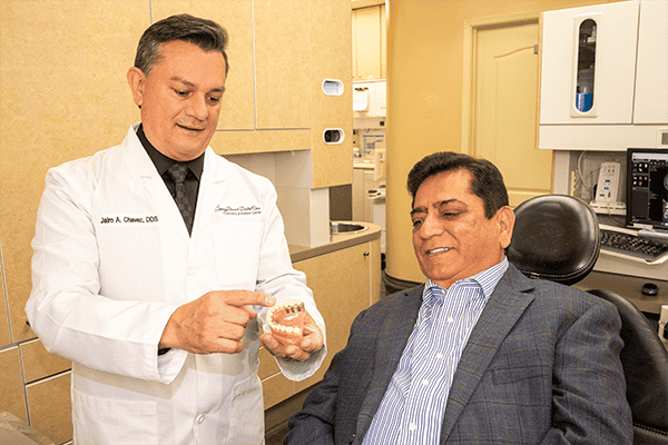 Dr. Chavez shows a patient regarding full-mouth reconstruction