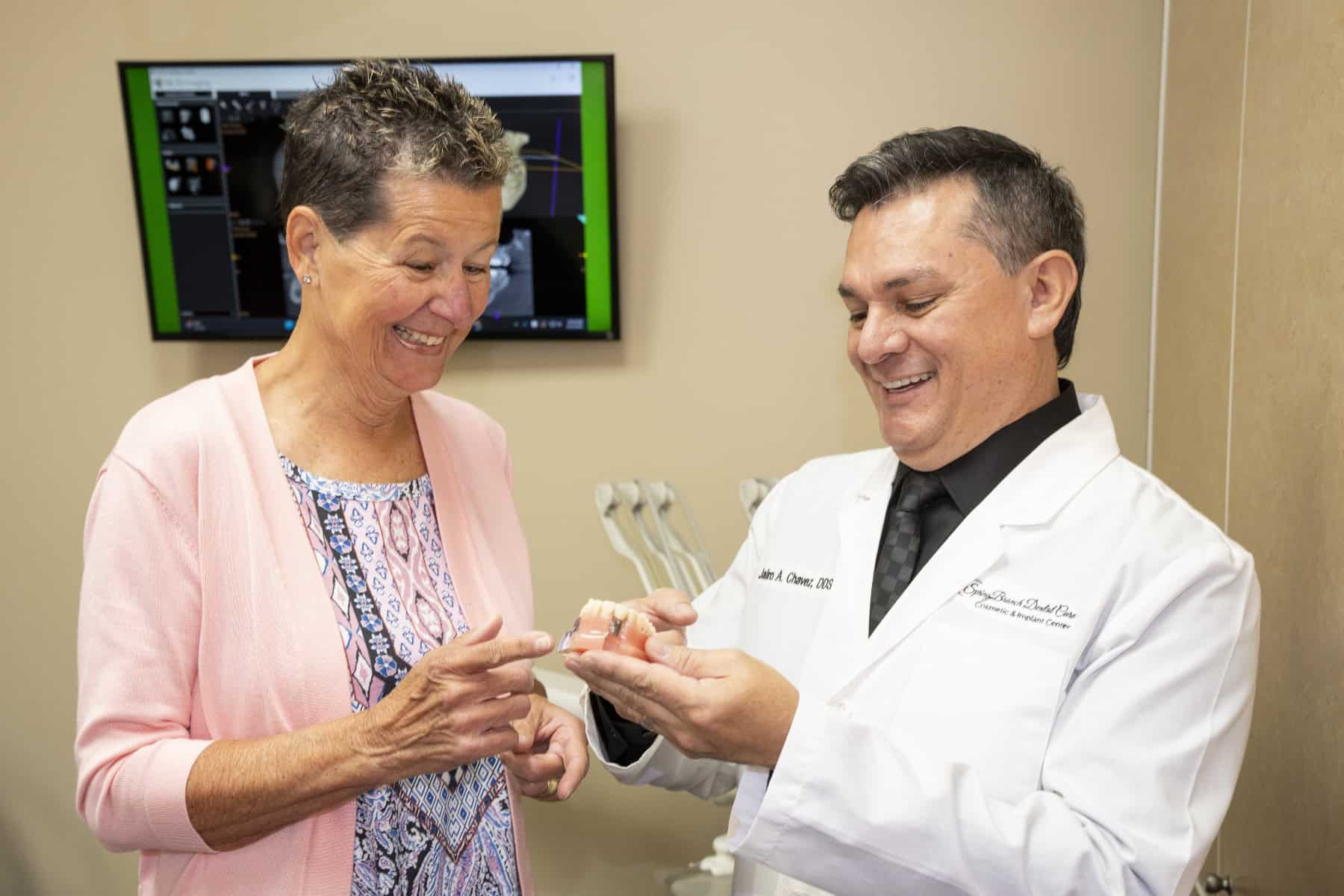 Dr. Chavez showing a patient a teeth model