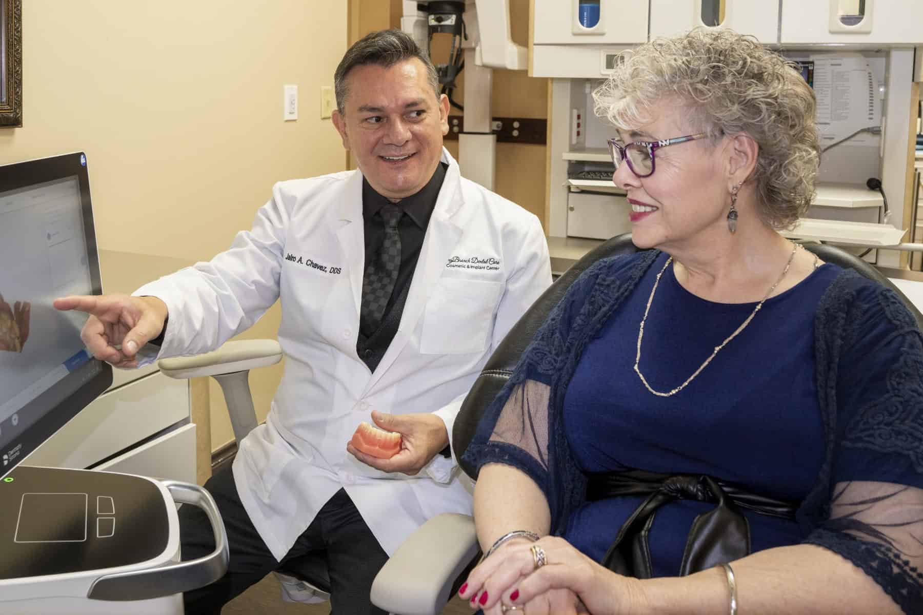 Dr. Chavez showing a patient a teeth model on a scanner