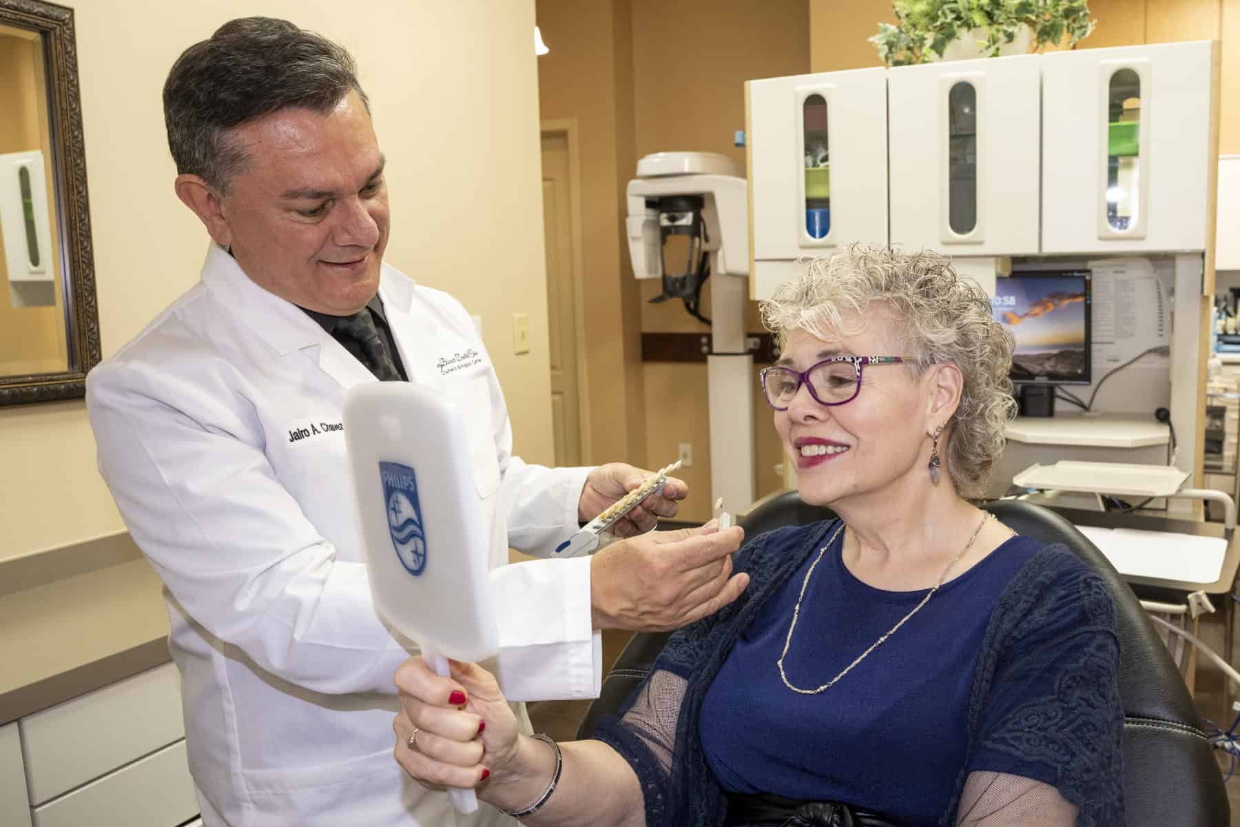 Dr. Chavez shows a patient some porcelain veneer models