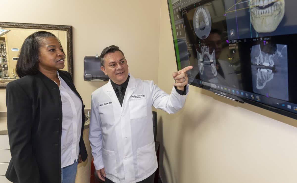 Dr. Chavez showing a patient X-ray scans on a screen