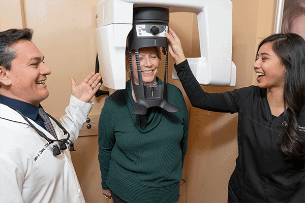 Dr. Chavez and his assistant use a 3D scanner on a patient