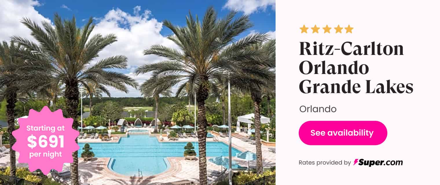 Luxury resort hotel Ritz-Carlton Orlando Grande Lakes with pool and palm trees.