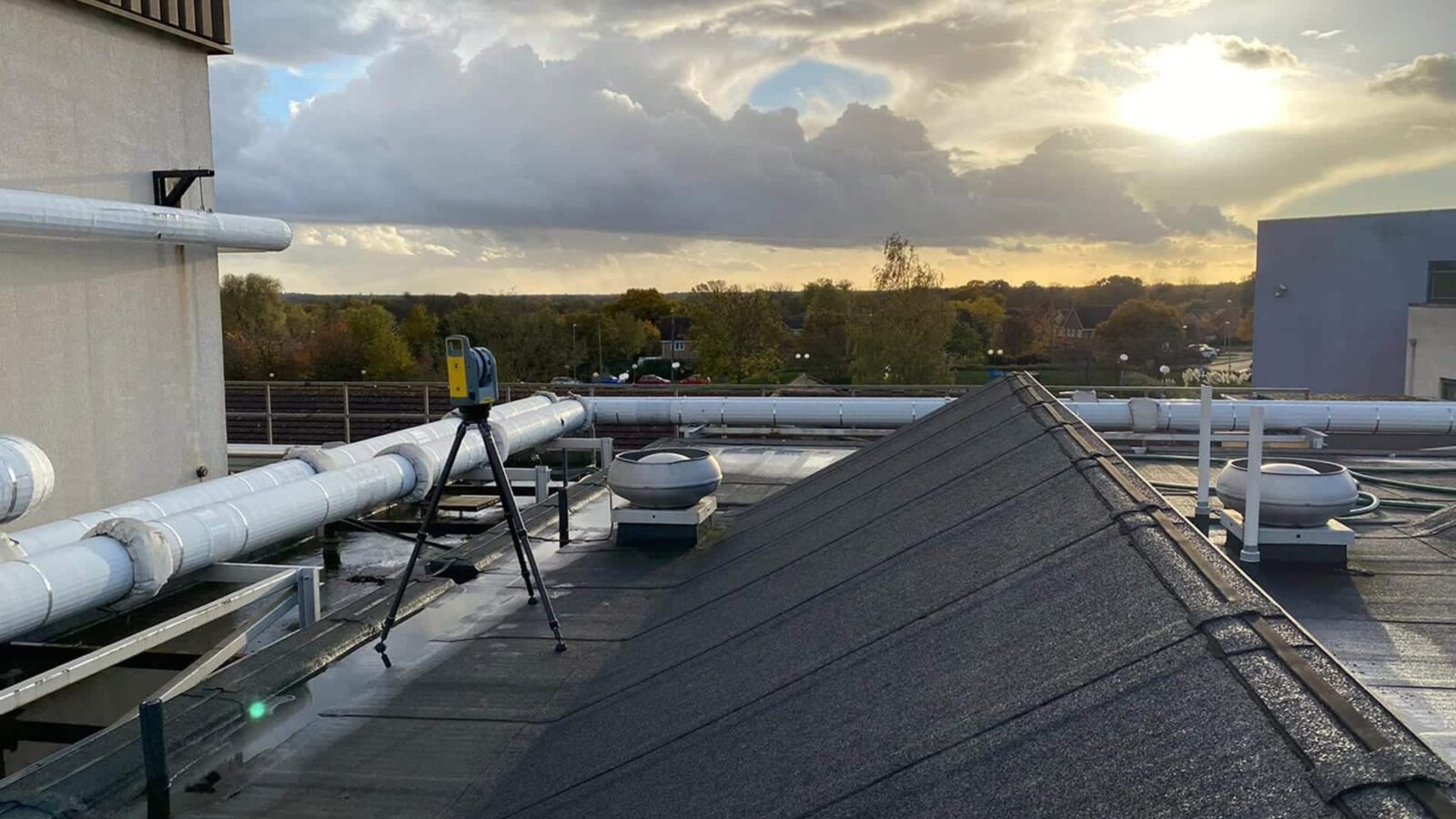 total station conducting raac survey on hospital roof