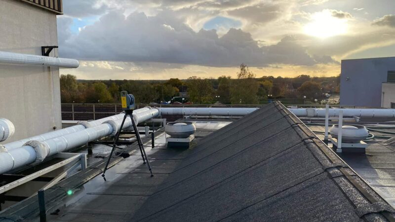 total station conducting raac survey on hospital roof