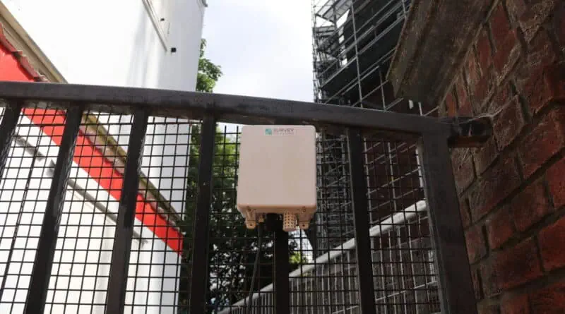 environmental monitor on the gates of a demolition site in haverstock hill