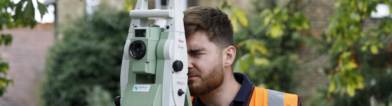 Surveyor carrying out a topographic survey